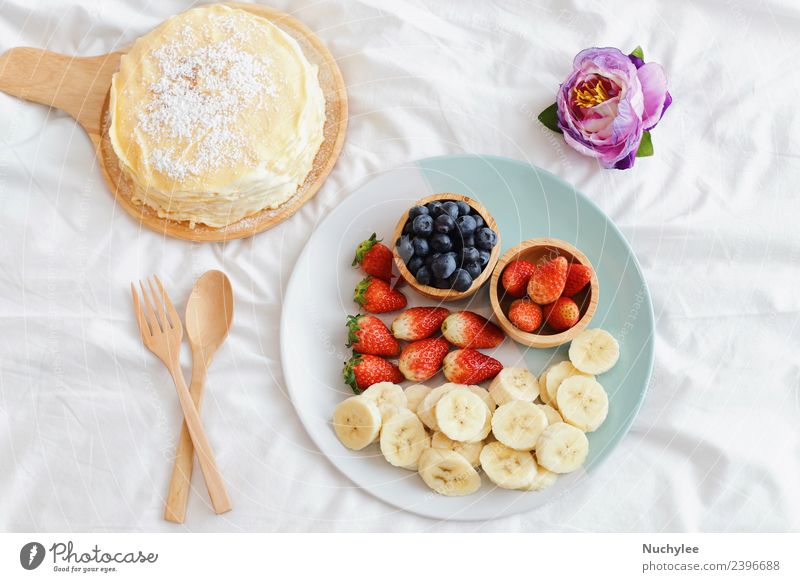 Tasty crape cake with fresh fruit Fruit Dessert Nutrition Eating Breakfast Fork Spoon Lifestyle Summer Flower Wood Fresh Delicious Natural White bed food