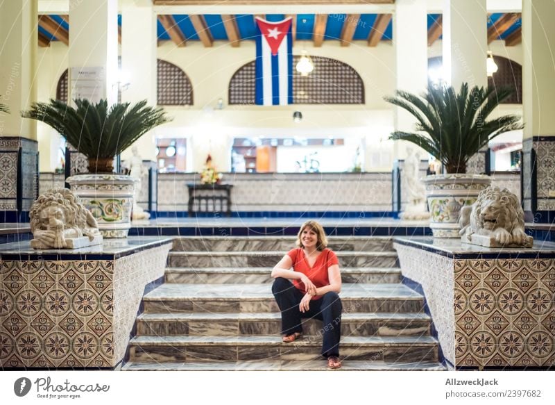 young woman sitting in front of hotel in Havana Cuba Island Socialism Vacation & Travel Travel photography Trip Sightseeing Hotel Flag Patriotism Wanderlust