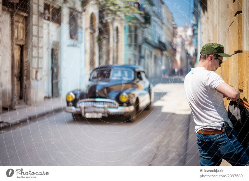 Man and classic car in a street in Havana Cuba Island Vacation & Travel Travel photography Trip Sightseeing Alley Street Town Blue sky Wanderlust Day Sun Summer