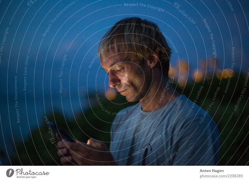 Man with mobile phone Adults 1 Human being 30 - 45 years Communicate Looking Cellphone Multicoloured Exterior shot Copy Space left Copy Space right Evening