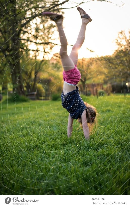 Girl does handstand Joy Happy Healthy Athletic Fitness Wellness Life Harmonious Well-being Garden Sports Training Child School Infancy Environment Nature Sky