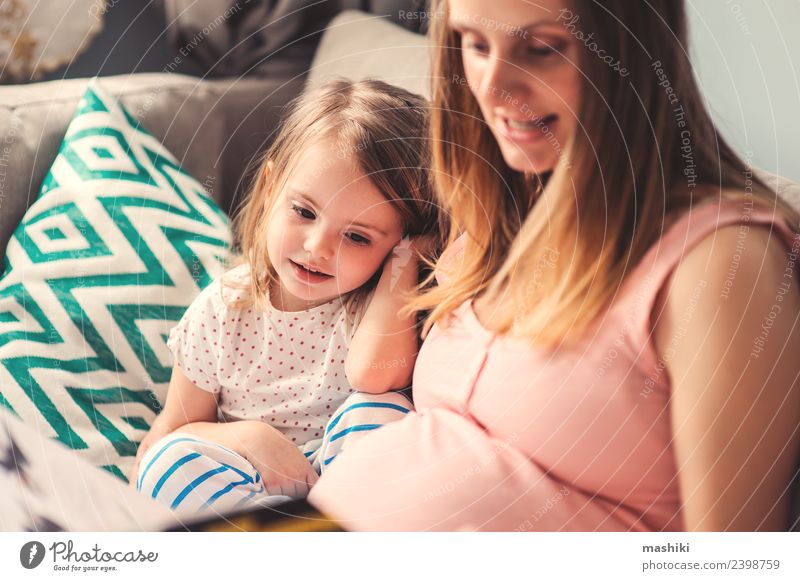 pregnant mom reading book to toddler daughter Joy Happy Beautiful Playing Reading Sofa Child Baby Toddler Parents Adults Mother Sister Family & Relations Book