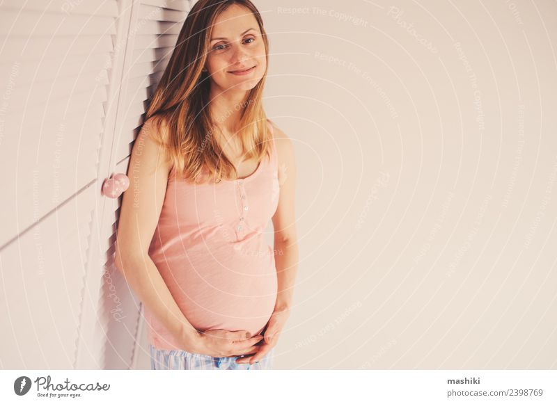 happy pregnant woman at home Lifestyle Happy Beautiful Woman Adults Mother Family & Relations Smiling Happiness Pink White Delightful Baby bump Caucasian