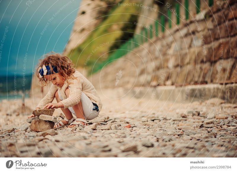 child girl playing with stones on the beach Joy Happy Beautiful Playing Vacation & Travel Summer Beach Ocean Child Sky Coast Stone Smiling Sit Small Cute Blue