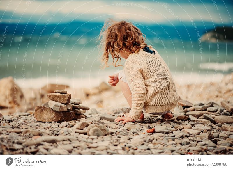 child girl playing with stones on the beach Joy Happy Beautiful Playing Vacation & Travel Summer Beach Ocean Child Sky Coast Stone Smiling Sit Small Cute Blue