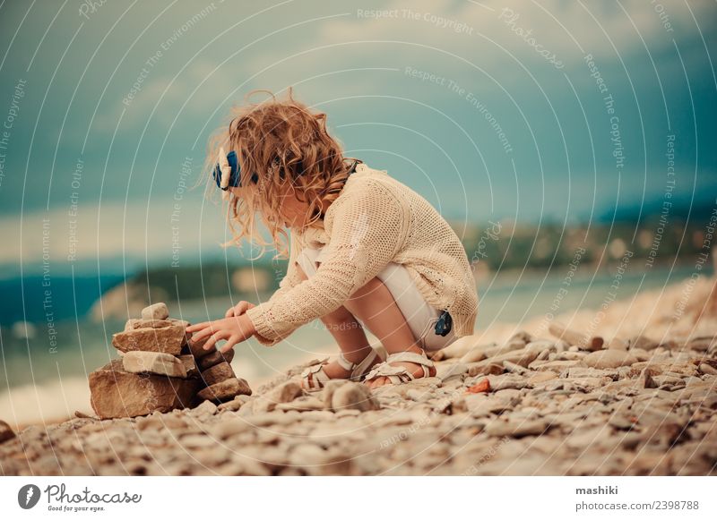 child girl playing with stones on the beach Joy Beautiful Playing Vacation & Travel Summer Beach Ocean Child Sky Clouds Rock Aircraft Stone Sit Small Cute Blue