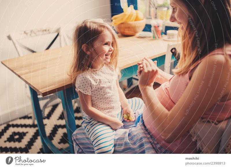 happy toddler girl playing with pregnant mother Breakfast Tea Joy Happy Beautiful Playing Table Kitchen Child Baby Toddler Parents Adults Mother