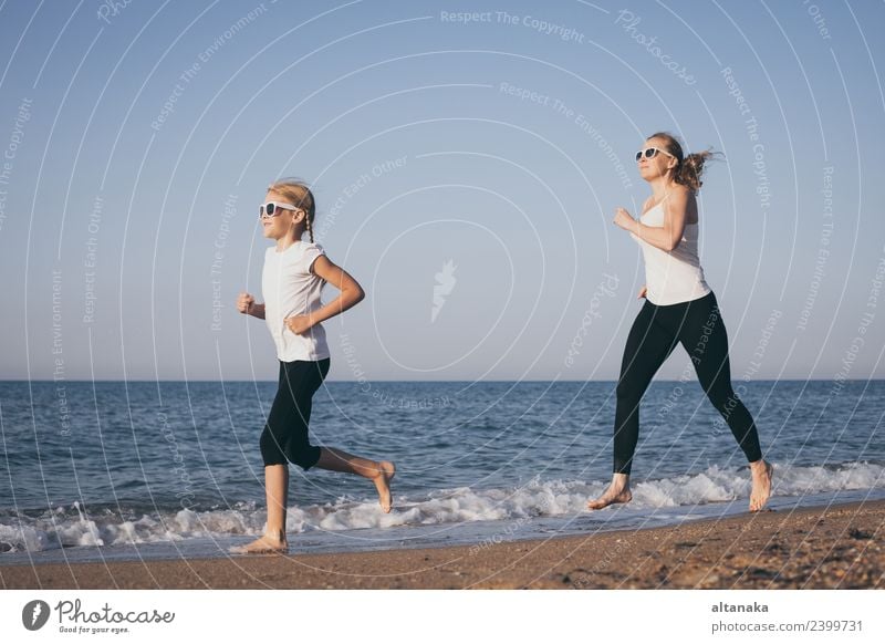 Mother and daughter running on the beach at the day time. Lifestyle Joy Happy Body Harmonious Relaxation Leisure and hobbies Camping Summer Beach Sports Child