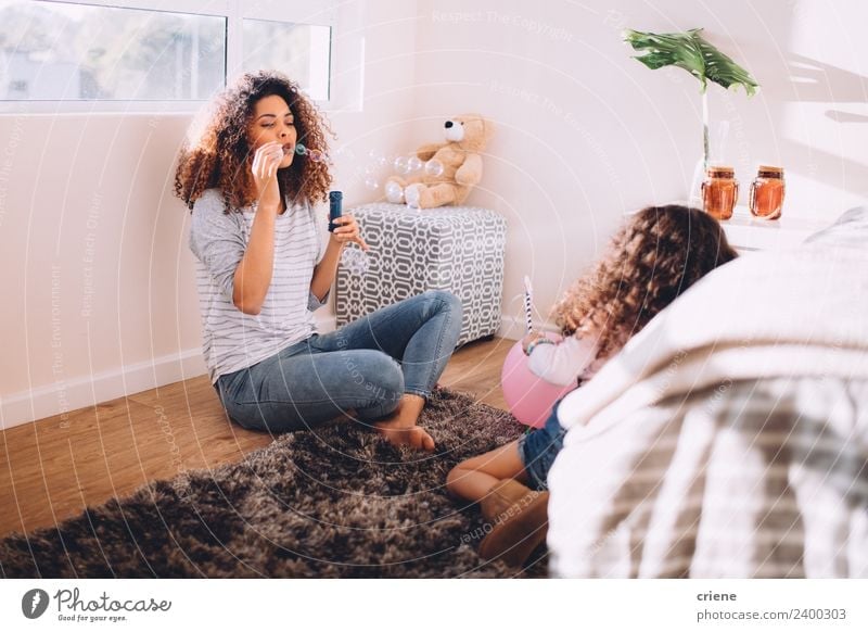 african mother and daughter having fun with bubbles at home Lifestyle Joy Happy Decoration Child Woman Adults Parents Mother Family & Relations Infancy Plant