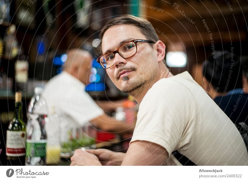Portrait young man with glasses at a bar Cuba Havana Bar Young man Eyeglasses Person wearing glasses Forward Contentment Dreamily Meditative Observe Think