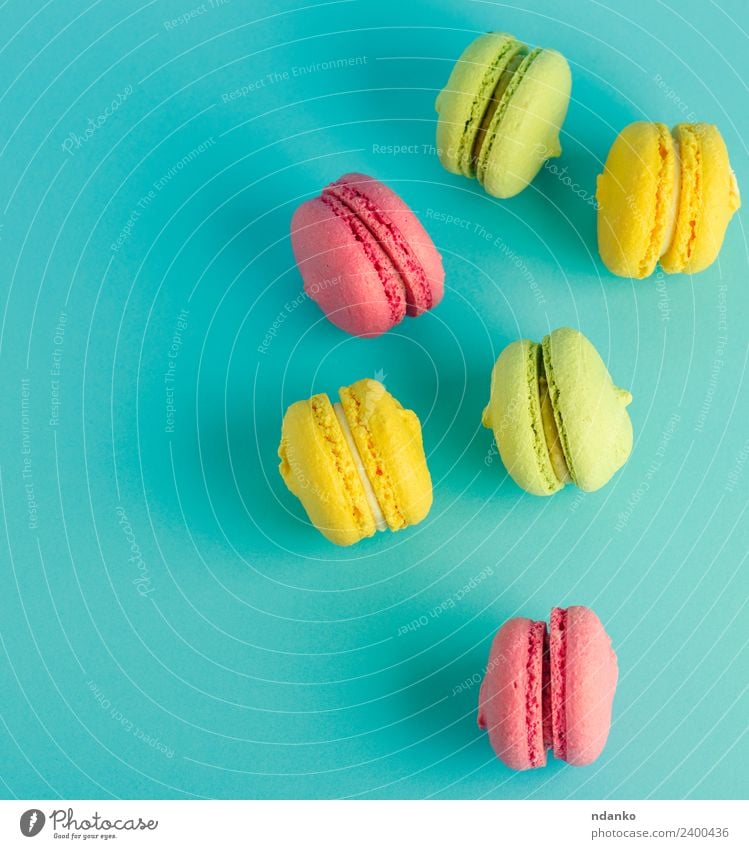 multicolored pastry with almond flour Dessert Candy Eating Bright Blue Yellow Green Pink Colour Macaron pastel background food colorful Vanilla french cake