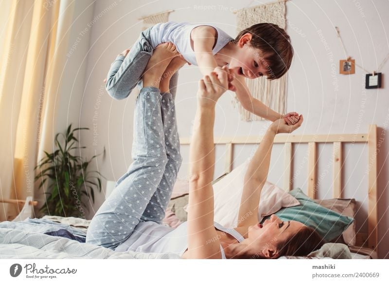 happy mother and child son fooling Lifestyle Joy Relaxation Bedroom Child Toddler Boy (child) Parents Adults Mother Family & Relations Infancy Flying Smiling