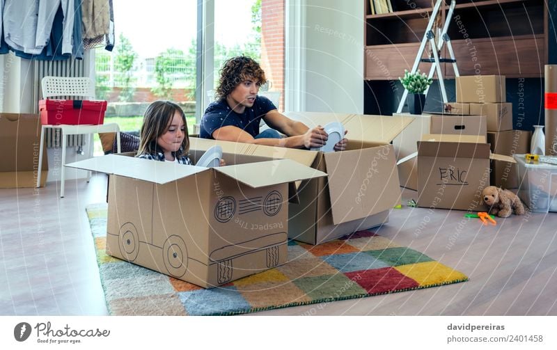 Father and son playing with cardboard boxes in living room Plate Lifestyle Joy Happy Relaxation Playing House (Residential Structure)