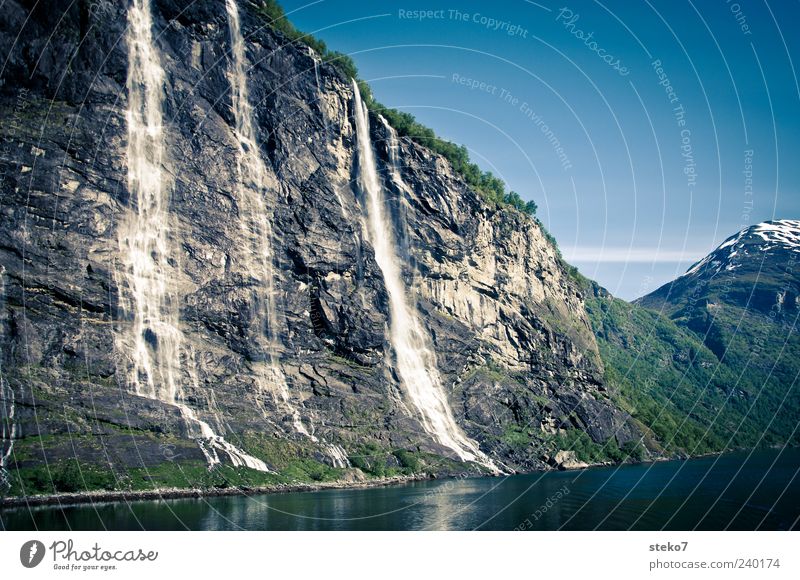 mountain flush Water Cloudless sky Snowcapped peak Fjord Waterfall Blue Gray Green Vacation & Travel Geirangerfjord Norway Card Colour photo Exterior shot