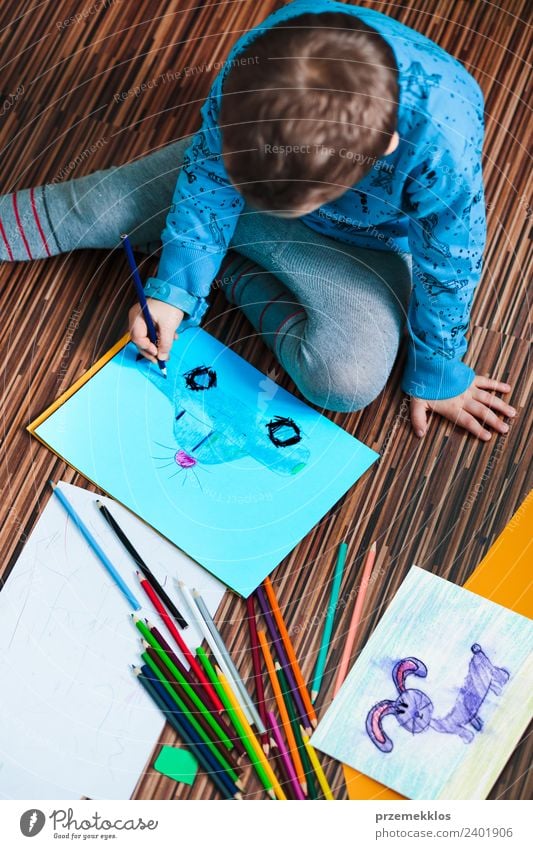 Little boy drawing a colorful picture Lifestyle Joy Handcrafts Education Kindergarten Child School Craft (trade) Human being Boy (child) Family & Relations