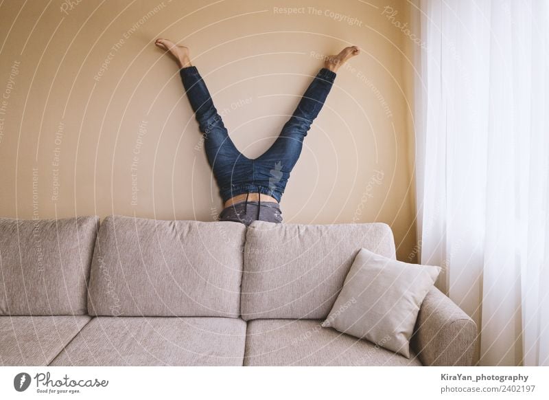 Adult man is standing on his head behind sofa in the room Lifestyle Health care Alternative medicine Athletic Fitness Leisure and hobbies Flat (apartment) Sofa