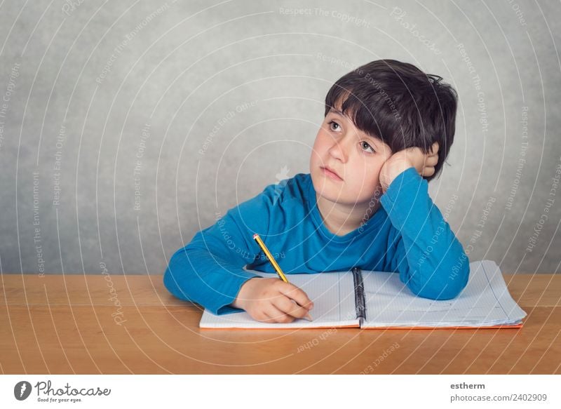 sad and pensive boy with a book on a table Lifestyle Education School Study Schoolchild Student Human being Masculine Child Toddler Infancy 1 8 - 13 years