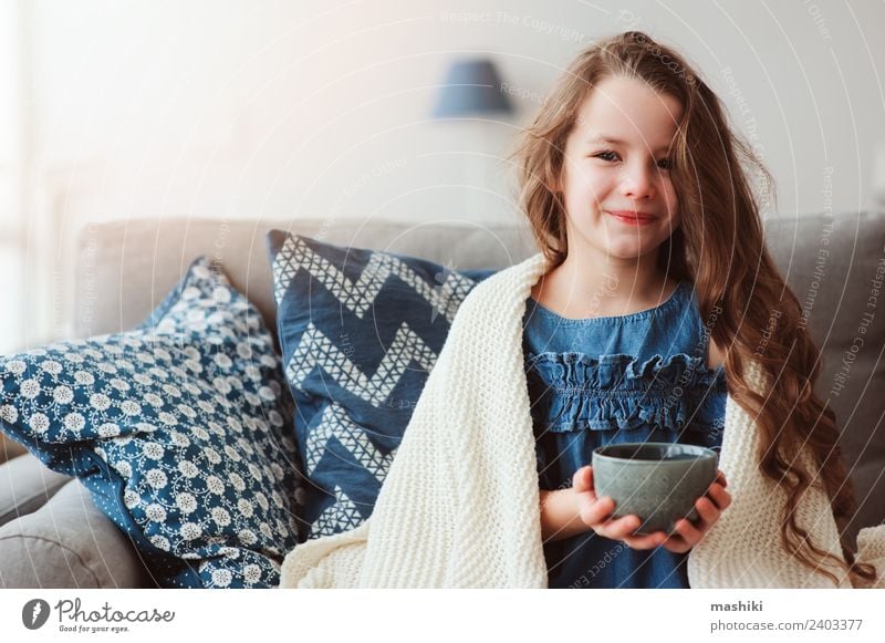 child girl drinking hot tea to recover from flu Tea Illness Relaxation Winter Living room Child Warmth To enjoy Smiling Sit Hot Small Modern Natural Tradition
