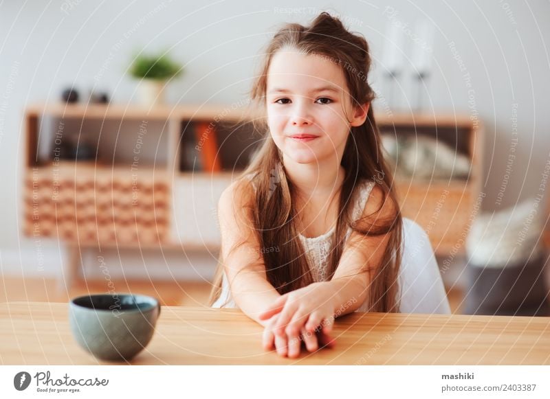 happy 5 years old kid girl having breakfast Nutrition Breakfast Hot Chocolate Tea Lifestyle Happy Table Kitchen Child Infancy Smiling Sit Authentic Modern