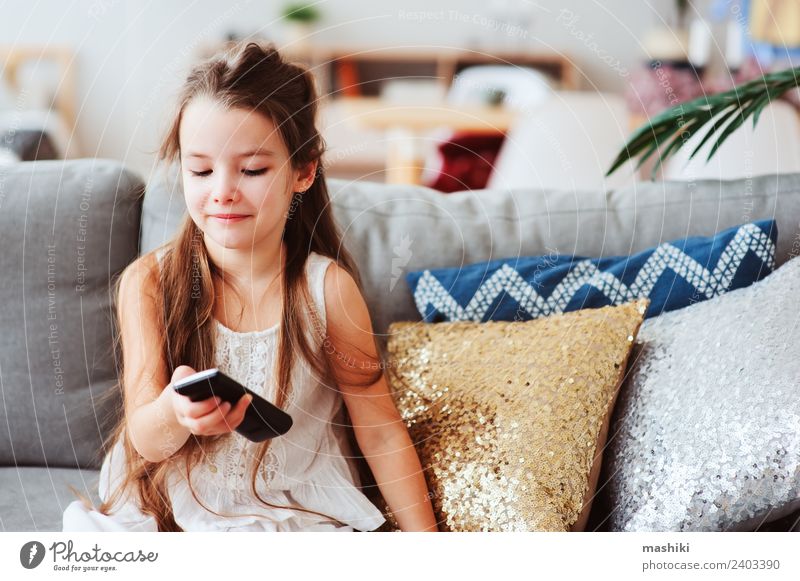 child girl watching tv at home Style Joy Happy Relaxation Living room Child School Technology Television Observe Sit Small Modern Safety (feeling of) Loneliness
