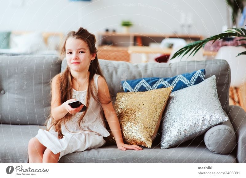 child girl watching tv at home Style Joy Happy Relaxation Living room Child School Technology Television Observe Sit Small Modern Safety (feeling of) Loneliness