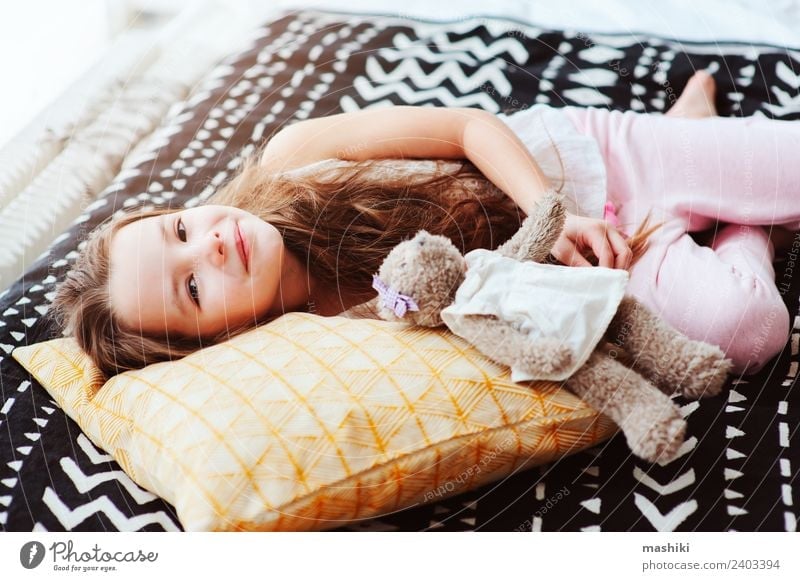 cute happy child girl relaxing at home Lifestyle Joy Relaxation Bedroom Child Smiling Sleep Dream Small Funny Energy kid bed Wake up nursery Pillow healthy