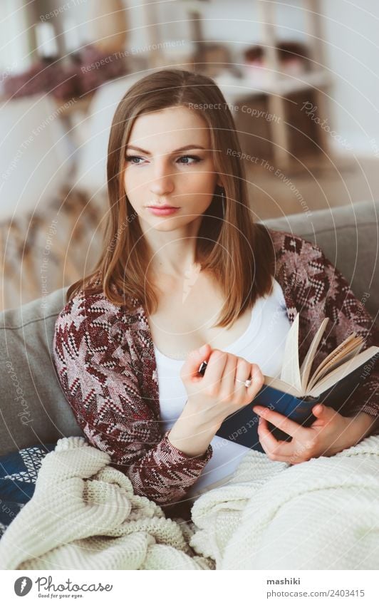 indoor portrait of young thoughtful woman Lifestyle Harmonious Relaxation Reading Winter Woman Adults Book Autumn Modern Natural Loneliness Home Cozy calm