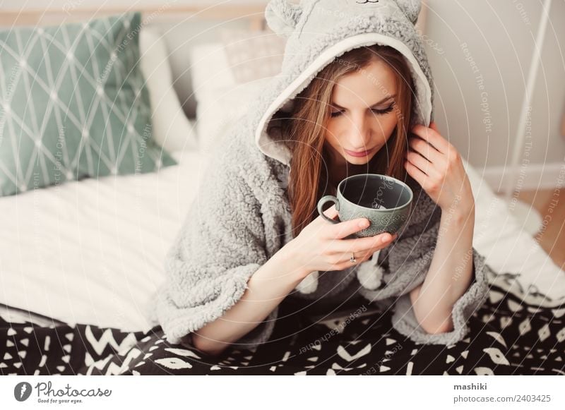 young beautiful woman relaxing at home on the bed Coffee Tea Lifestyle Relaxation Bedroom Woman Adults Culture Warmth Fashion Sit Dream Considerate Home Cozy