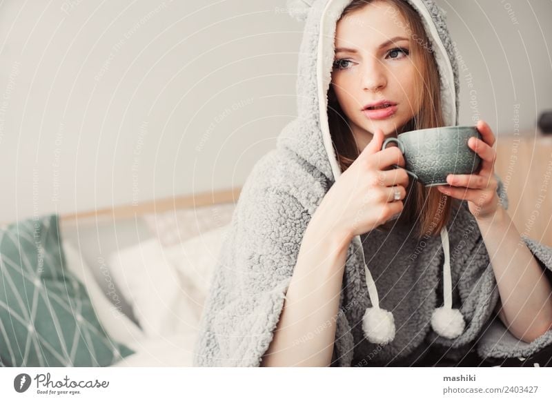 young beautiful woman relaxing at home Coffee Tea Lifestyle Relaxation Bedroom Woman Adults Culture Warmth Fashion Sit Dream Modern Natural Loneliness