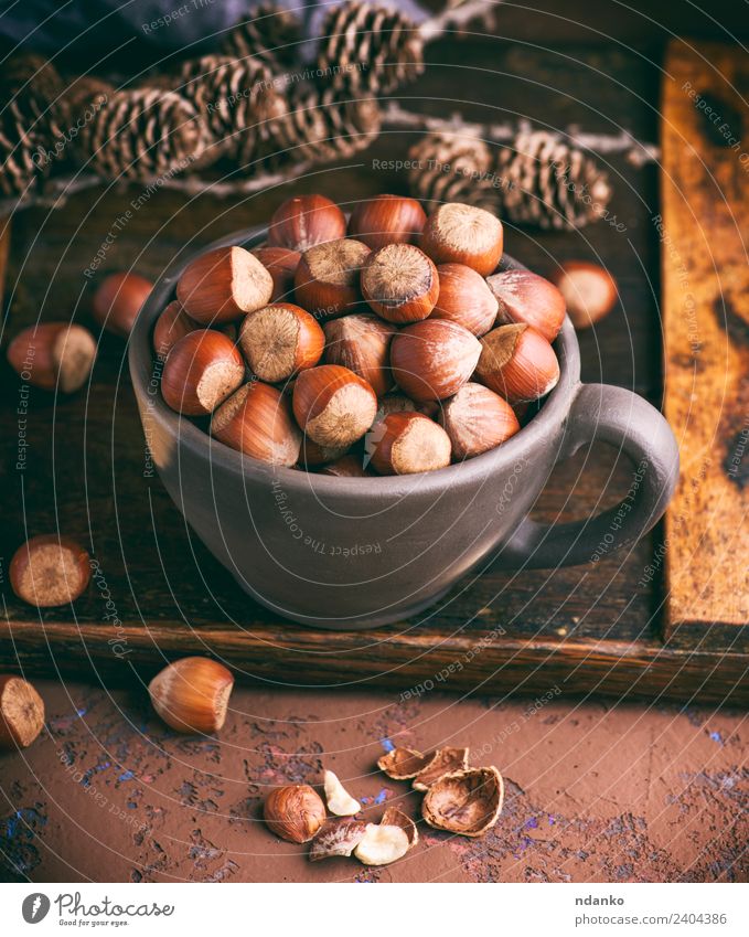 hazelnut in a shell Fruit Nutrition Vegetarian diet Plate Bowl Wood Eating Fresh Natural Above Brown background Organic food many seed Nutshell Tasty Snack