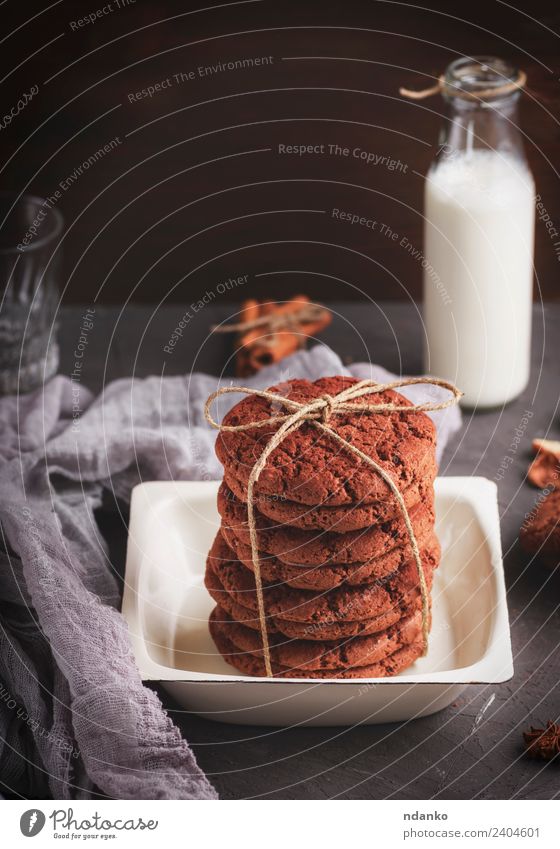 baked round cookies tied with a rope in an iron plate Dairy Products Dessert Candy Nutrition Breakfast Milk Plate Bottle Rope Dark Delicious Brown Black White
