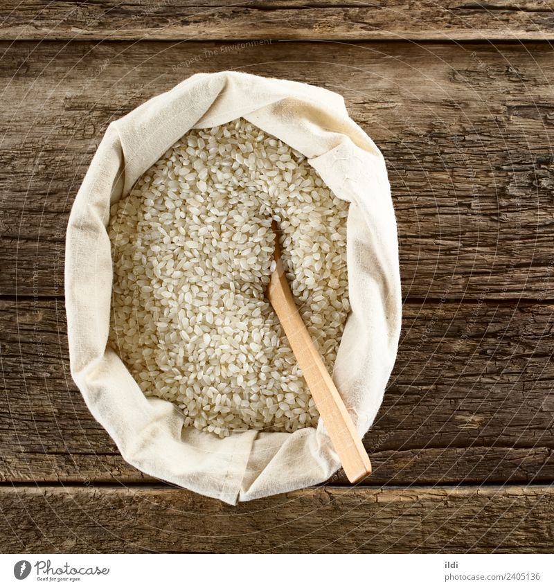 Raw Arborio Risotto Rice Grain Nutrition White food arborio risotto Italian Ingredients cooking European dry Dried Staple Cereal starchy bag overhead Top Rustic