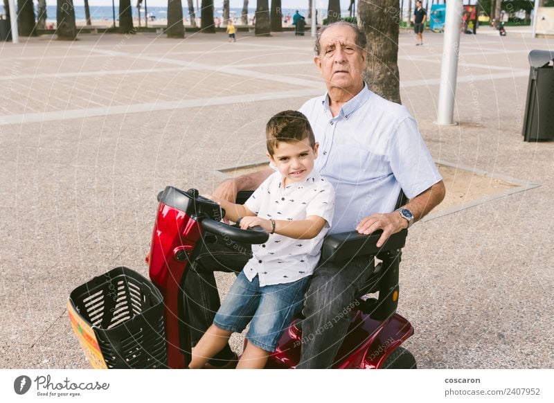 Grandfather and grandson with a electric wheelchair Summer Chair Child Engines Human being Boy (child) Man Adults Nature Transport Vehicle Old Mobility