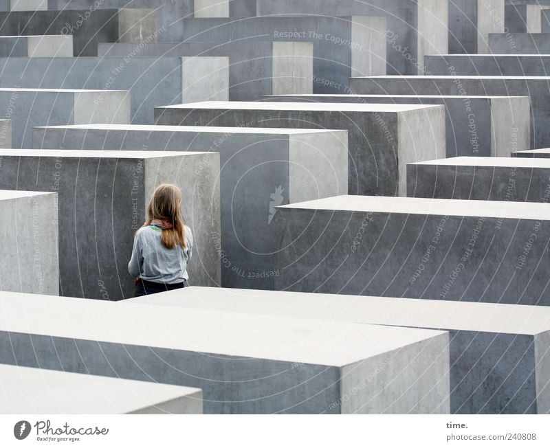 Trying to grasp the immeasurable girl Monument Stone Gray Stelenfeld Berlin Memory Cuboid Corridor Visit Inspection Structures and shapes Shadow Sunlight