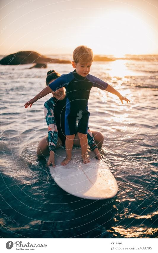 caucasian mother is helping son to learn how to surf Lifestyle Joy Happy Leisure and hobbies Vacation & Travel Summer Beach Ocean Sports Child Toddler
