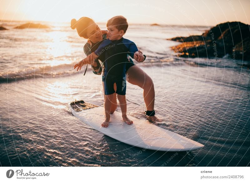 caucasian mother and son practicing surfing Lifestyle Joy Happy Leisure and hobbies Vacation & Travel Summer Beach Ocean Sports Child Toddler Boy (child) Mother