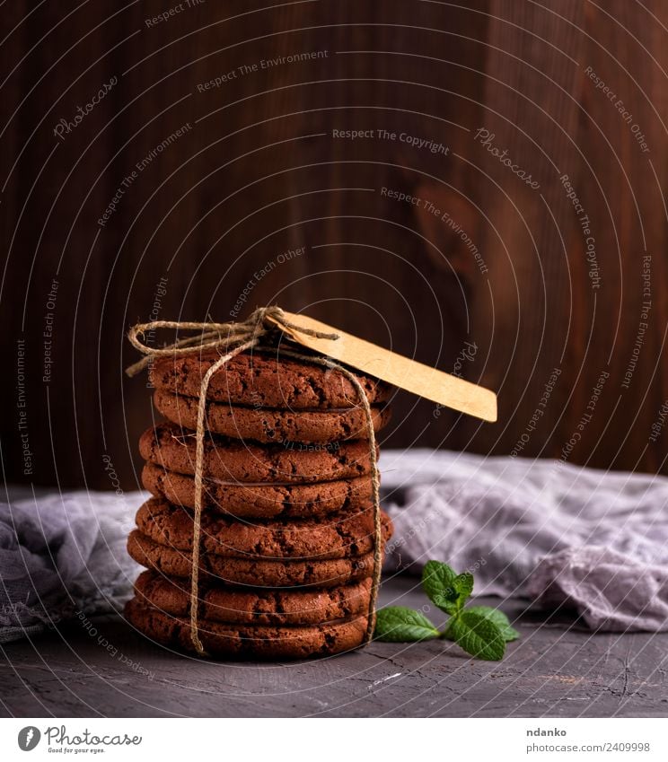 round chocolate cookies Dessert Candy Nutrition Rope Eating Delicious Brown Black background food Stack sweet Baking biscuit holiday Tasty Snack Mint tag