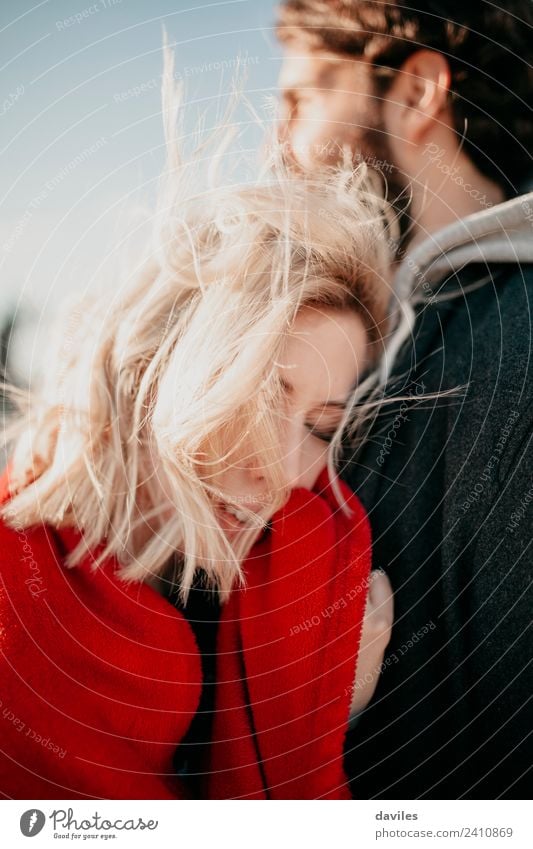 Blonde woman hugging her boyfriend with closed eyes. Lifestyle Sun Winter Woman Adults Man Couple Fashion Beard Love Embrace Cool (slang) Together Modern Red