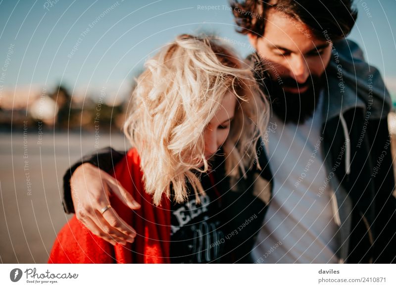 Blonde woman and bearded man walking together outdoors. Lifestyle Joy Woman Adults Man Couple Fashion Beard Smiling Love Embrace Cool (slang) Happiness Together