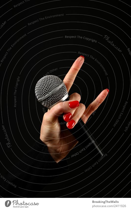 Woman hand holding microphone with devil horns on black Feminine Young woman Youth (Young adults) Adults Hand Fingers Punk Shows Music Concert Stage Singer