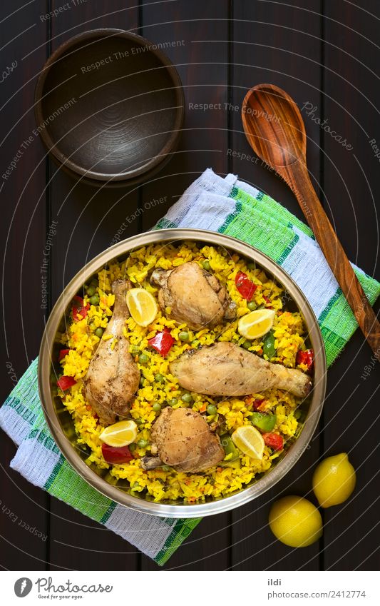Spanish Chicken Paella Meat Vegetable Fresh paella poultry Thigh Rice Dish Meal food Valencian Mediterranean cooking Pepper Peas legume Pulse Lemon citrus