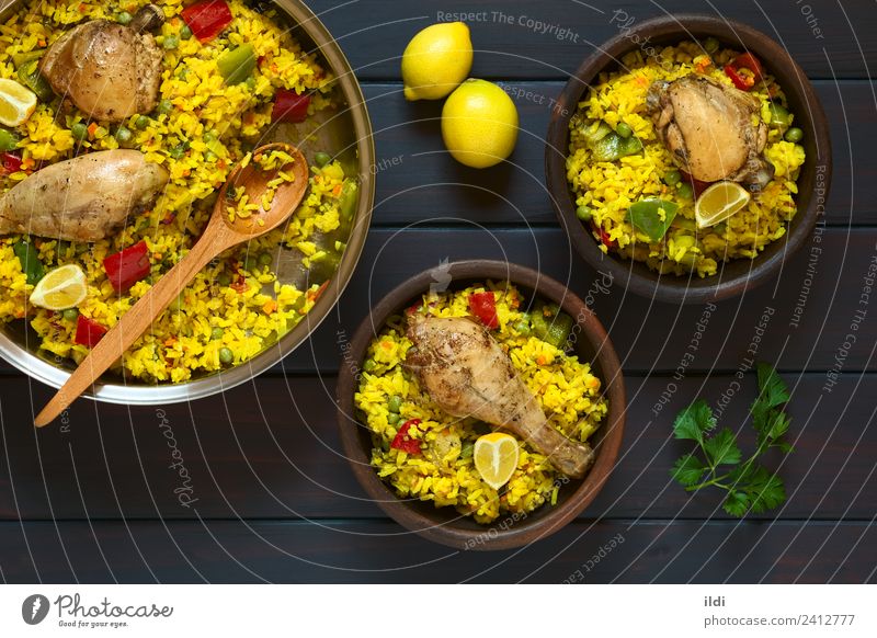 Spanish Chicken Paella Meat Vegetable Fresh paella poultry Thigh Rice Dish Meal food Valencian Mediterranean cooking pepper Peas legume Pulse Lemon Rustic