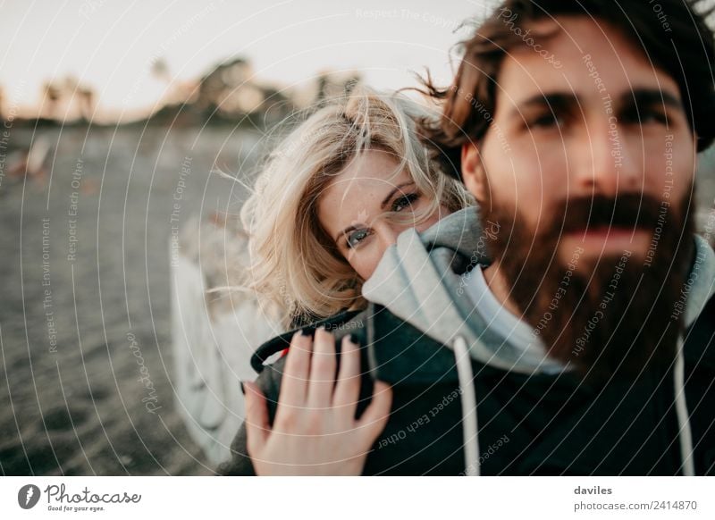 Young blonde woman hugging her boyfriend and looking at camera. Lifestyle Human being Young woman Youth (Young adults) Young man Woman Adults Man Couple Partner