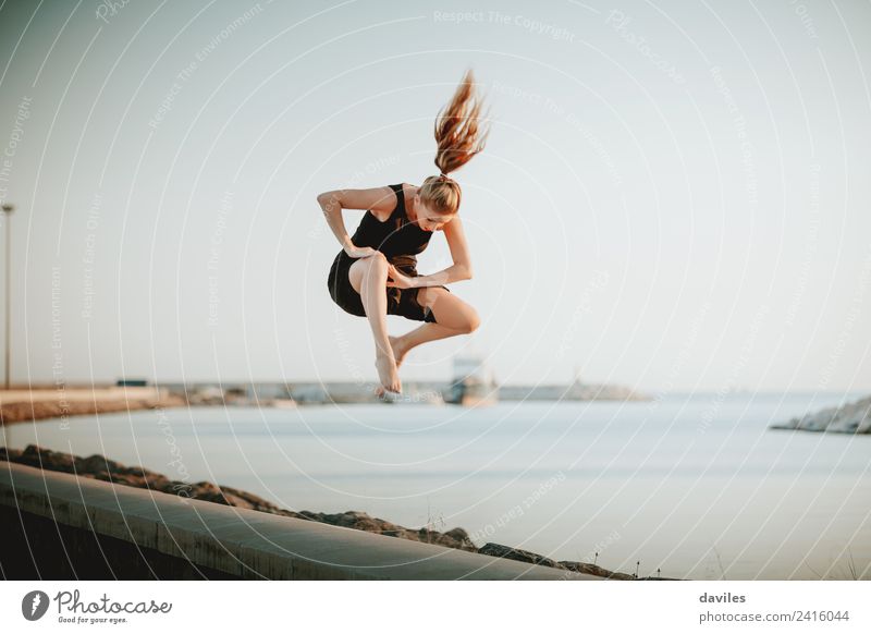 Strong white woman jumping in the air during contemporary dance performing. Lifestyle Joy Leisure and hobbies Handcrafts Vacation & Travel Sun Ocean Dance