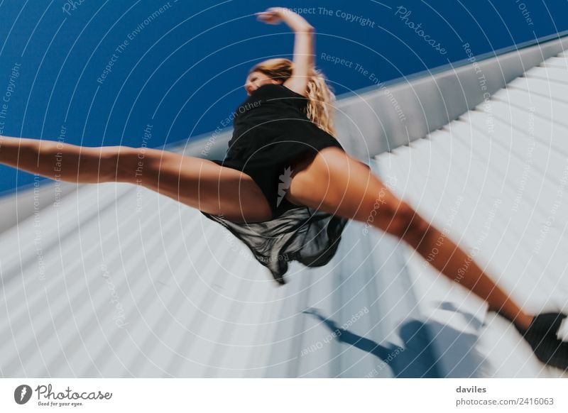 Low angle view of woman in black dress jumping Lifestyle Elegant Dance Sports Fitness Sports Training Human being Feminine Young woman Youth (Young adults)