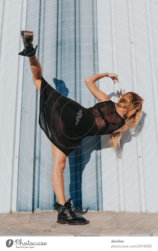Blonde white woman in black dress performing contemporary dance, raising up the leg. Lifestyle Body Dance Sports Human being Woman Adults Youth (Young adults) 1