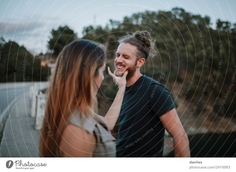 Cool couple interacting together outdoors Lifestyle Joy Human being Woman Adults Man Friendship Couple Hand Nature Forest Bridge Beard Smiling Laughter Love