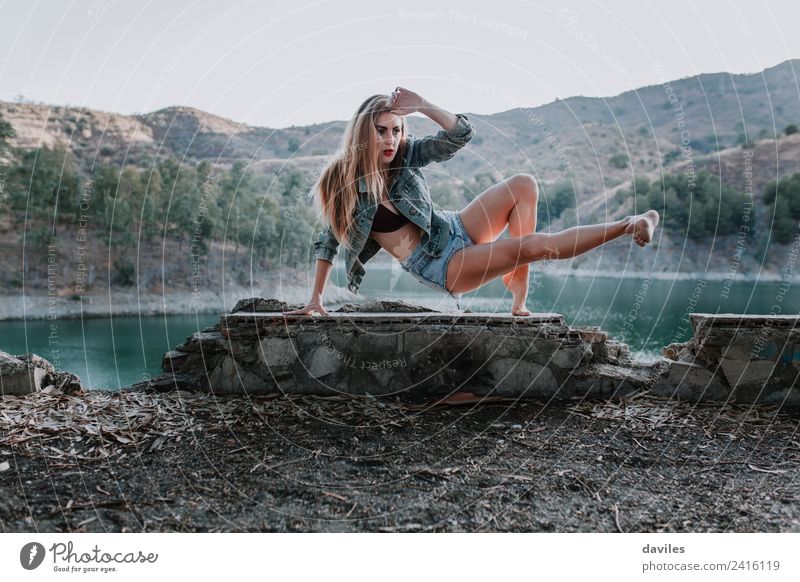 Woman in jeans and underwear performing contemporary dance in nature. Lifestyle Style Beautiful Face Mountain Human being Adults 1 18 - 30 years