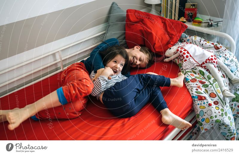 Brother and sister tickling and laughing on bed Lifestyle Joy Happy Playing Bedroom Child Human being Boy (child) Woman Adults Man Sister Family & Relations