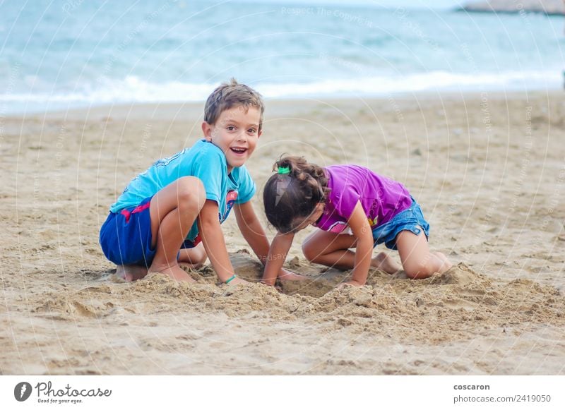 Two kids digging on the beach Joy Playing Summer Beach Ocean Child Baby Boy (child) Couple Sand Smiling Happiness Small back Digging girl kidvacation two water